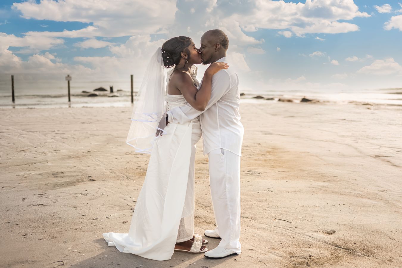 Newlyweds walking along Indian Rocks Beach shoreline at sunset