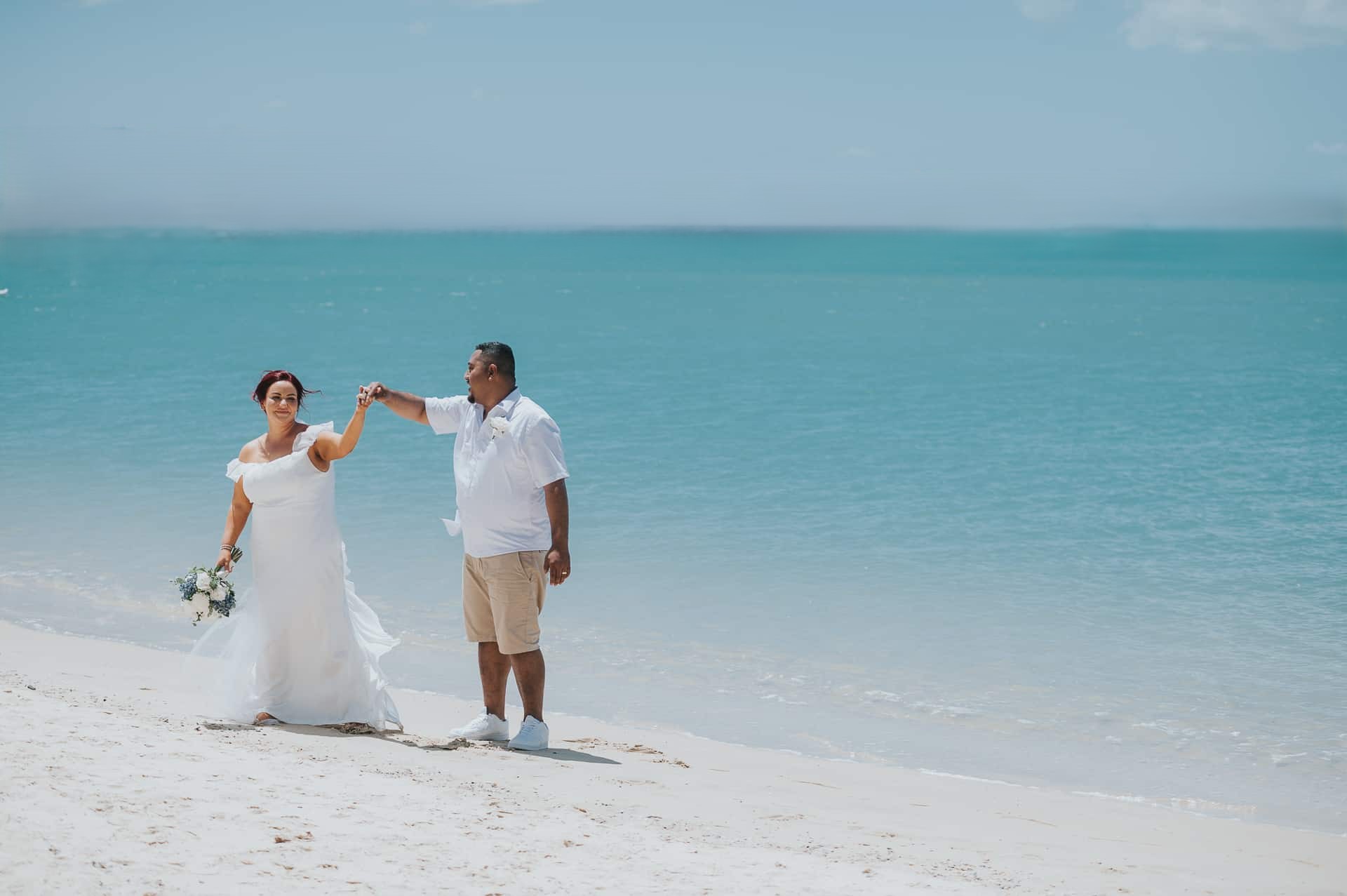 Bride and groom portraits on the shoreline at Sand Key Beach