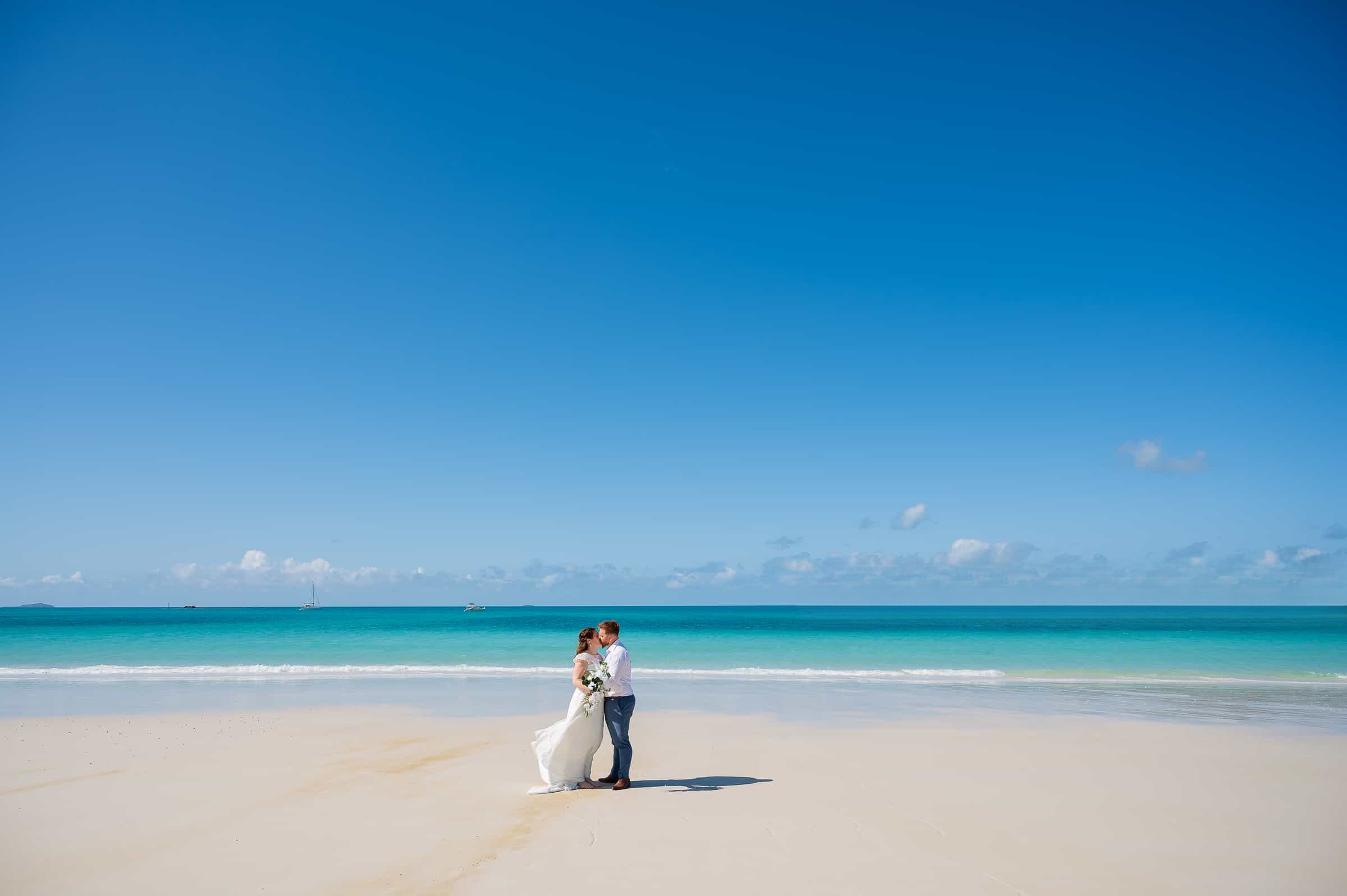 Newlyweds walking the shoreline after their Florida destination wedding