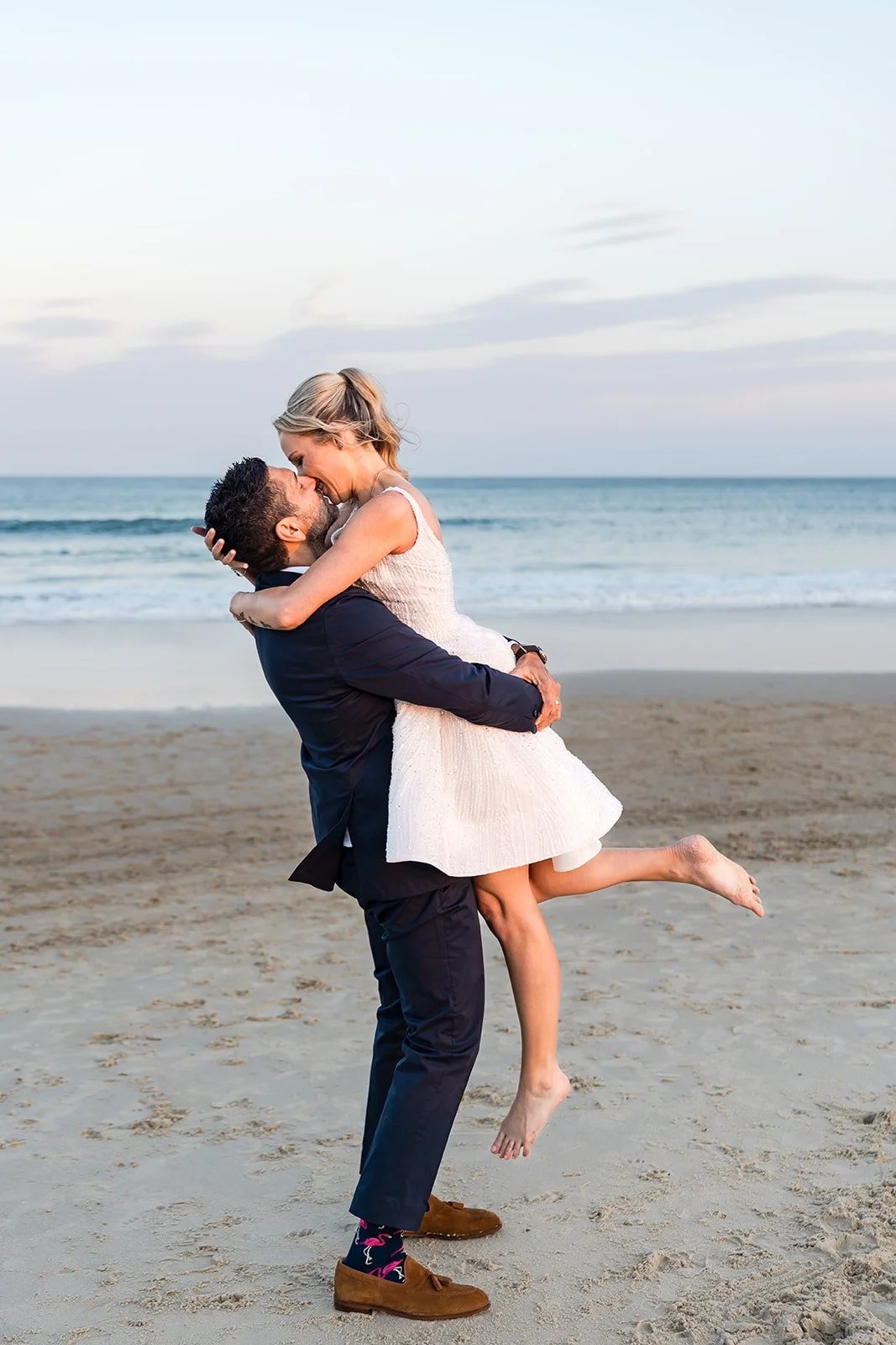 Newlyweds celebrating on the sand at Indian Rocks Beach