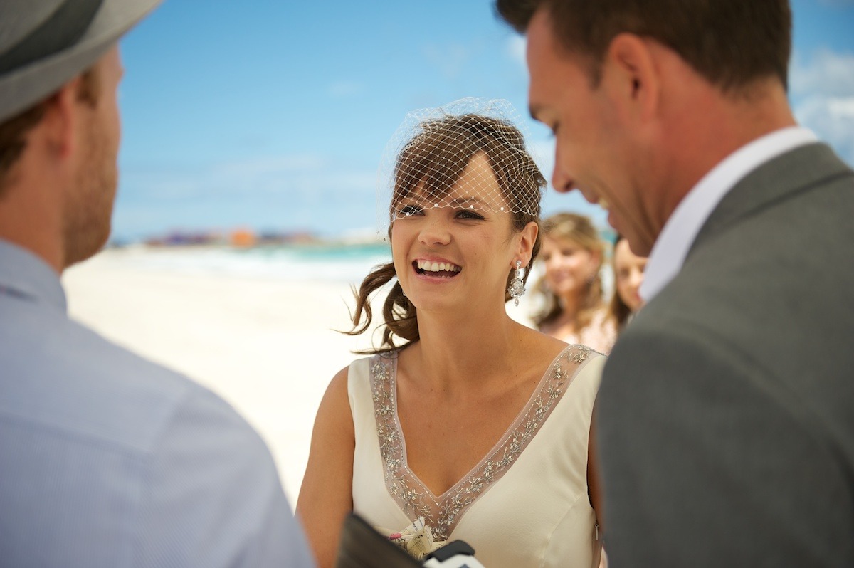 Couple exchanging vows at Clearwater Beach sunset wedding